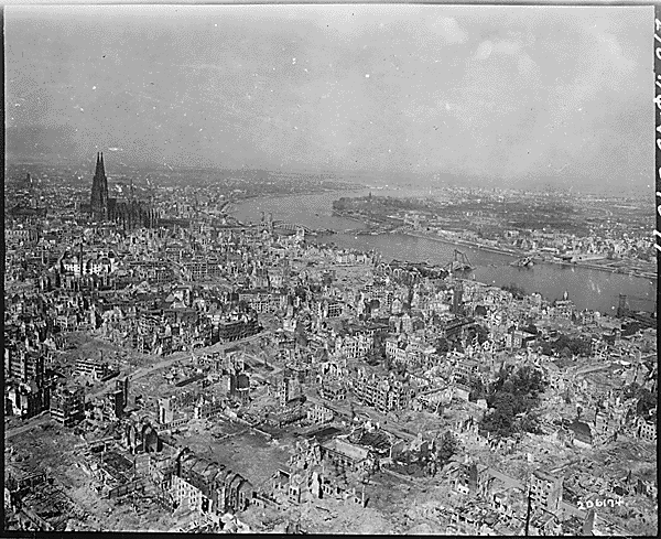 Cologne Cathedral stands undamaged while entire area surrounding it is completely devastated. Railroad station and Hohenzollern Bridge lie damaged to the north and east of the cathedral. Germany, April 24, 1945. (National Archives)