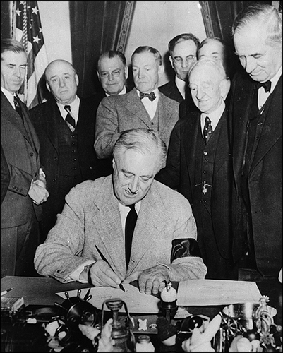 President Franklin D. Roosevelt signs a declaration of war in 1941. "War Time," a variation on daylight-saving time, followed. Again the idea was to save fuel. Photo Credit: Hulton Archive/Getty Images/NPR
