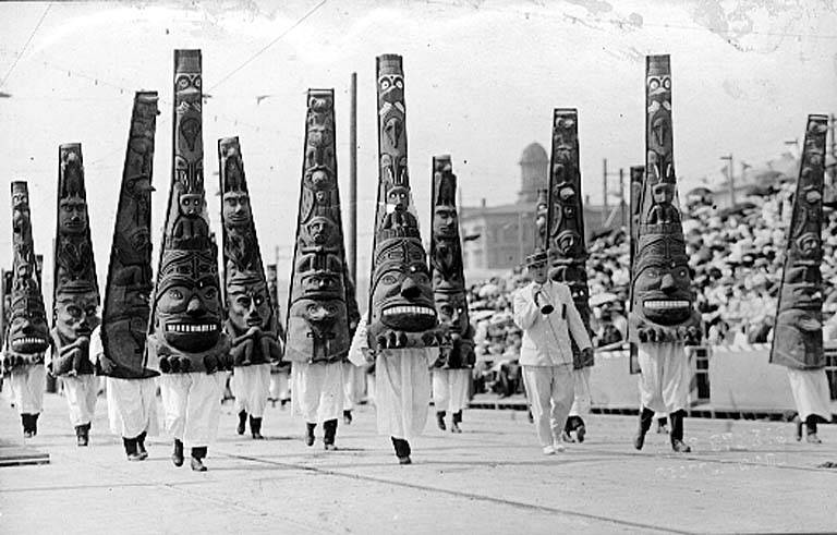Totem-wearing parade participants, 1912