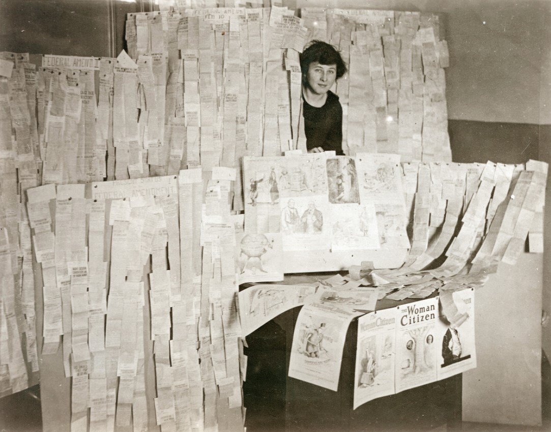 Suffragette with newspaper clippings, 1919